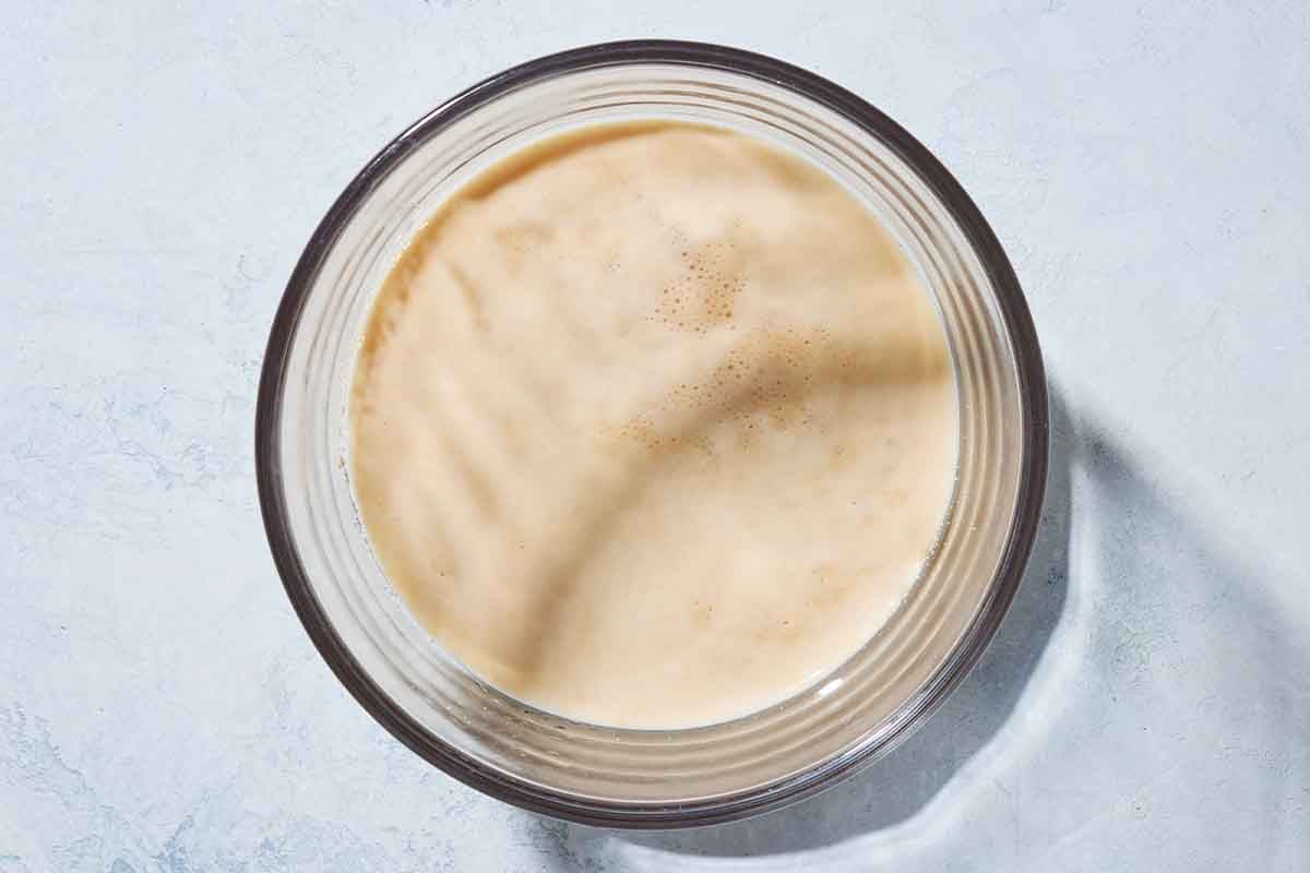 Yeast activating in a small bowl with sugar and warm water.